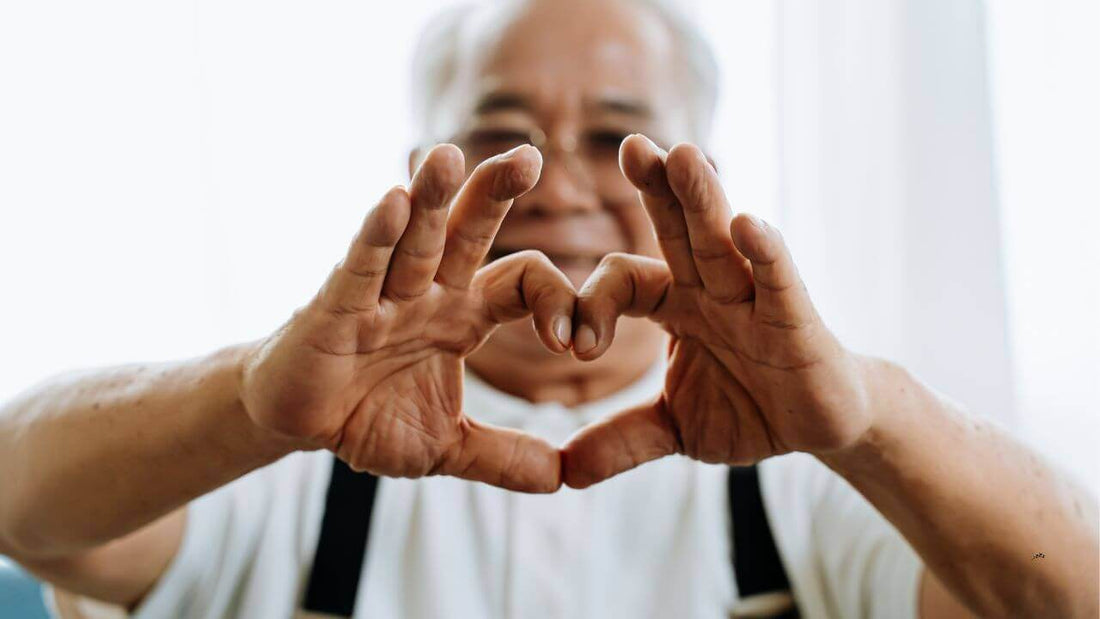 man forming a hand heart