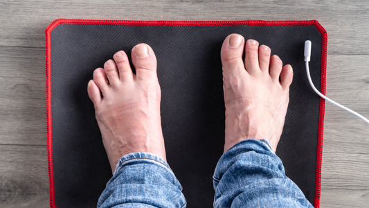 How Does It Feel to Be Grounded? Person standing on a grounding mat with bare feet.