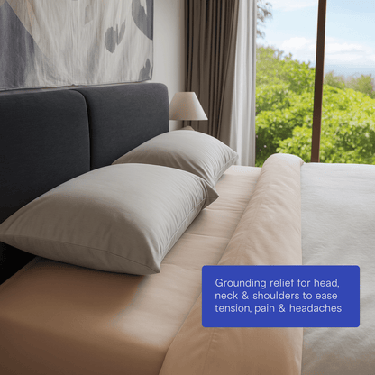 grounding pillows on bed with tree in background