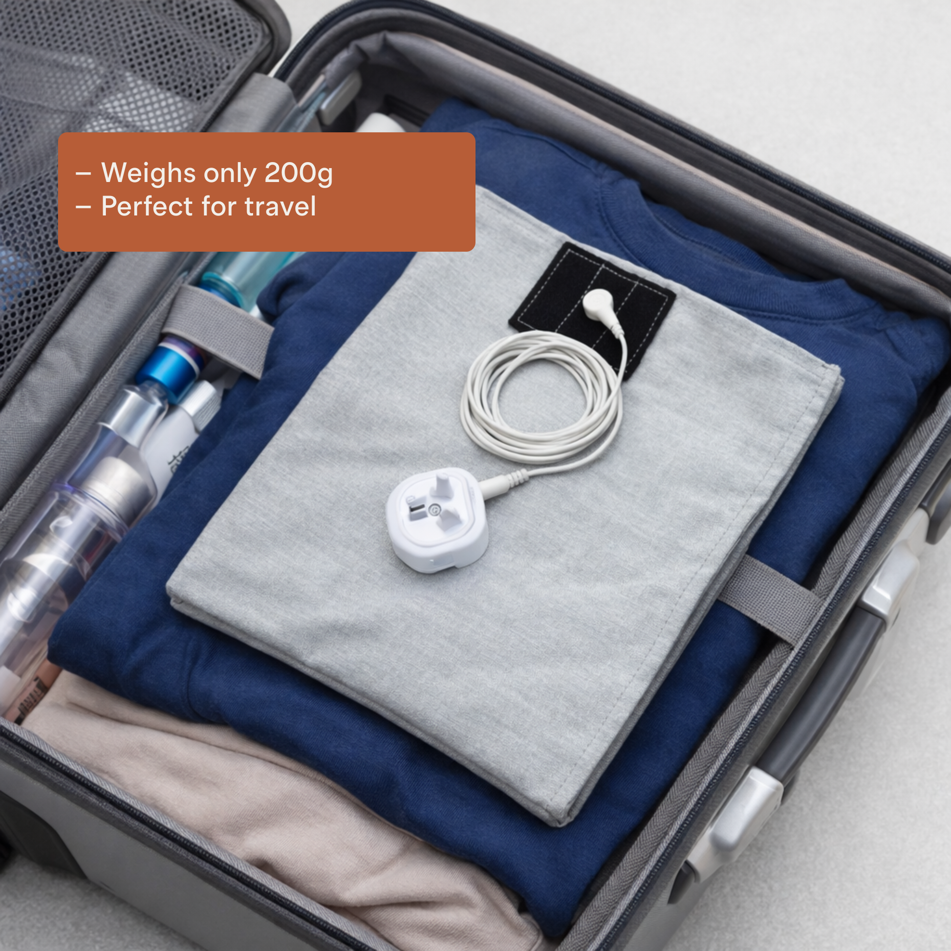 Multi-Purpose Grounding Pad in suitcase with clothes, lightweight at 200g, ideal for travel use.
