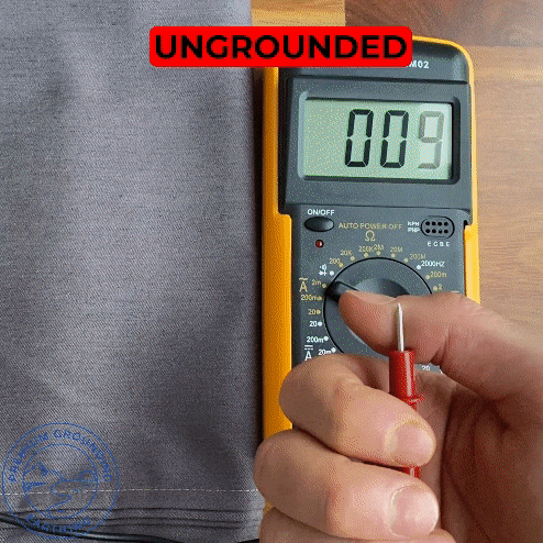 hand touching grounding sheet and reducing voltage with multimeter