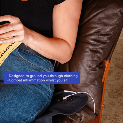 Stainless steel grounding mat placed beside bed for sleep grounding