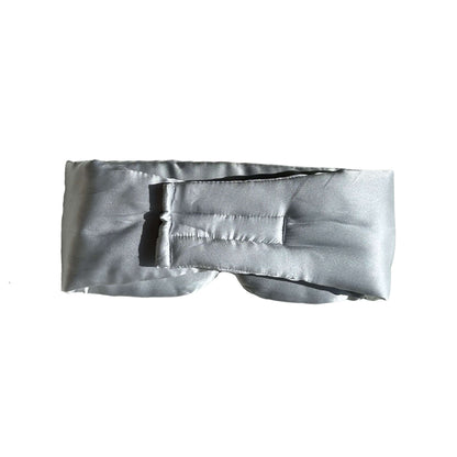 Woman wearing a silk sleep mask while resting on a pillow